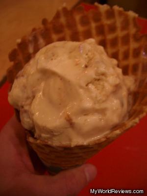 Cinnamon bun ice cream in a waffle cone
