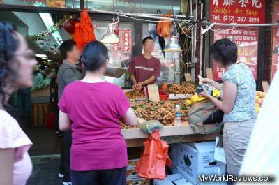 Buying lychee fruit from a street vendor