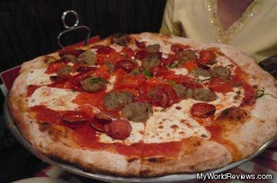 Pizza with pepperoni, roasted red peppers, and meatballs