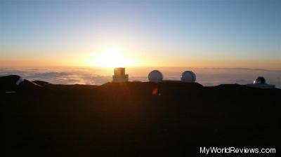 The sun setting into the clouds from the summit of Mauna Kea